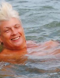 Mature granny Dimonty skinny dipping at the beach with big saggy tits hanging
