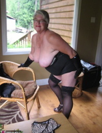 Fat oma Girdle Goddess releases her shaved pussy from her underwear on a chair